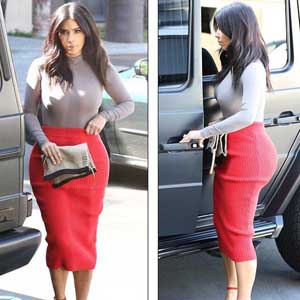 Kim Kardashian in a high-waisted woolen rouge red skirt