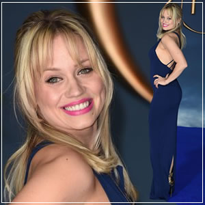 Kimberly Wyatt dressed in a stylish gold and backless dress